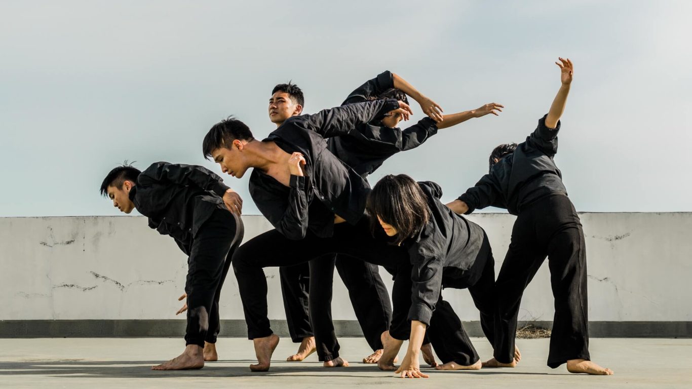 six-people-in-black-matching-clothes-dancing-at-daytime-690597